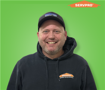 male employee wearing a black SERVPRO shirt and hat