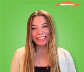 female employee with long hair smiling
